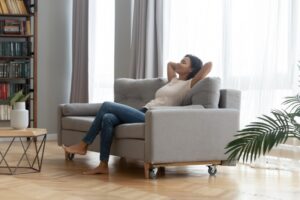 woman-sitting-on-couch-looking-comfortable